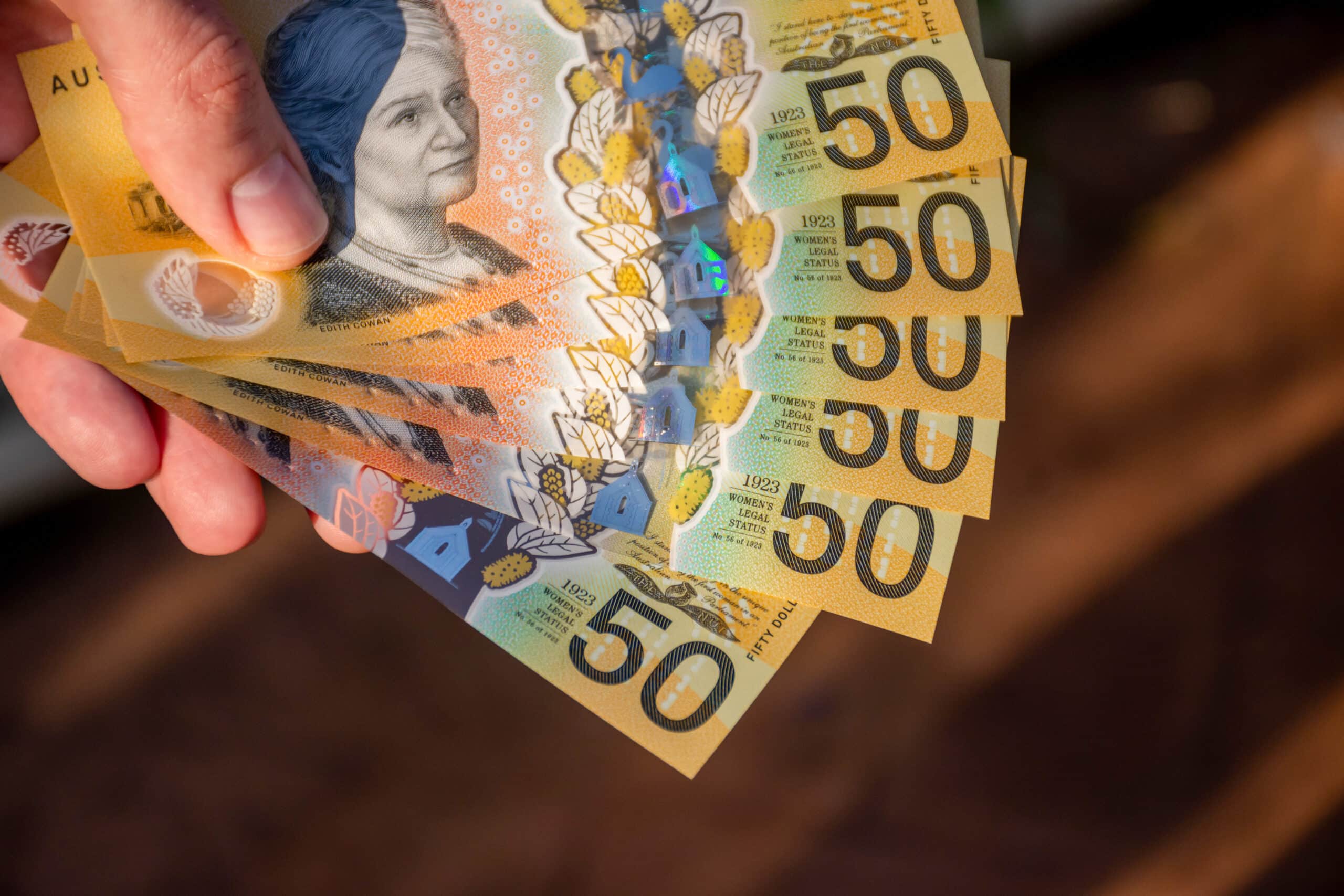 hands holding australian dollars